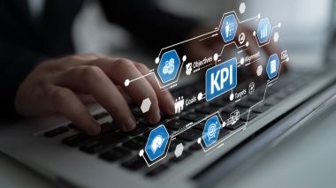 Business professional uses a laptop to analyze key performance indicators with a modern interface, focusing on efficiency and achieving organizational goals. Tessel