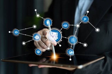 A focused businessman interacts with a tablet, showcasing innovative technology and digital connections in a modern workspace, highlighting efficiency and professionalism. Tessel