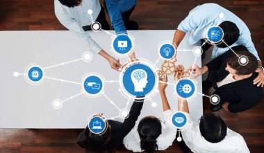 In a modern business setting, diverse team members collaborate around a table, integrating technology and innovative ideas to drive effective problem-solving and successful outcomes. Amity