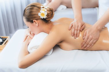 Kafkas çift müşterisi stres önleyici spa masajının keyfini çıkarıyor ve lüks otel veya oteldeki gündüz açık hava ortamında güzellik teniyle eğleniyor. Sessiz.