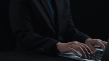 A futuristic hands-on approach to technology, showcasing a holographic user interface above a laptop, emphasizing digital innovation in business and data management. Qubit