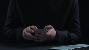 A visual representation of global communication featuring hands using a smartphone with various languages displayed around a digital globe, emphasizing connectivity and technology. Qubit