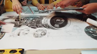 A group of engineers collaborates over detailed technical drawings and schematics of a jet engine, showcasing teamwork and innovative technical planning in a modern workshop setting. SACTR