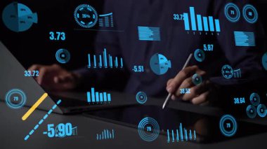 A person examines various data visualizations on a digital interface, showcasing growth trends and analytics in a high-tech business environment. Xenic