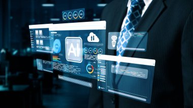 Bir işadamı, iş dünyasının başarısı için yenilik ve teknoloji entegrasyonunu vurgulayarak, çağdaş bir ofiste yapay zeka veri analizleri sergileyen ileri dijital arayüzlerle ilgileniyor. Dörtgen