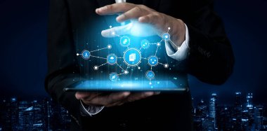 A business professional interacts with a futuristic tablet displaying holographic technology. This image symbolizes innovation, connectivity, and modern corporate trends in a digital world. Tessel