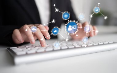 Hands on a keyboard illustrate technology and communication concepts, featuring digital icons that represent connections in a modern office environment. Tessel