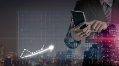 A businessman analyzes a financial growth chart on a smartphone, showcasing an upward trend with currency symbols, set against a city skyline backdrop. Copula