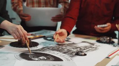 A group of engineers collaborates on aircraft engine design, examining technical drawings and components in a modern workspace filled with creativity and teamwork. SACTR