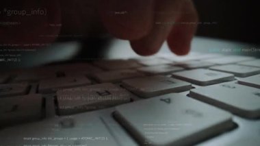 A close-up image of hands typing on a keyboard, with programming code overlaid in the background, representing technology, software development, and digital innovation. Xenic