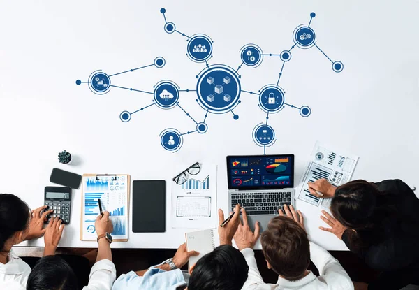 A diverse team engages in collaborative business planning, analyzing data through charts and graphs, fostering innovation and insights in a modern office environment. Amity