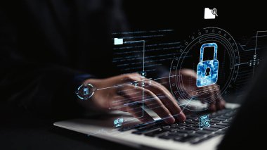 A close-up view of hands actively typing on a laptop, with an overlaid graphic of a digital lock, highlighting the importance of cybersecurity and data protection in today digital world. Qubit