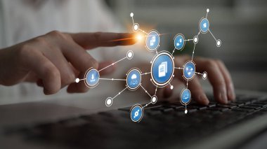 An engaging image showcasing a hand interacting with digital icons on a keyboard, representing technology and communication in a modern workspace environment. Tessel