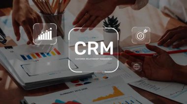 A dynamic business meeting showcasing teamwork around customer relationship management. Focus on effective strategies with charts and graphs in a modern office environment. Raster