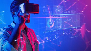 A young man engages with a virtual reality headset as he explores a vibrant digital interface filled with analytics and graphs, showcasing a high-tech environment. Raster
