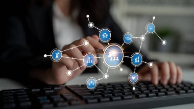 A business professional engages with a digital interface featuring various network icons. This image represents modern technology solutions and data connectivity. Tessel