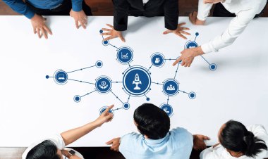 A diverse group of professionals engages in a brainstorming session, analyzing business strategies on a modern table with a central rocket concept, emphasizing collaboration and innovation. Amity