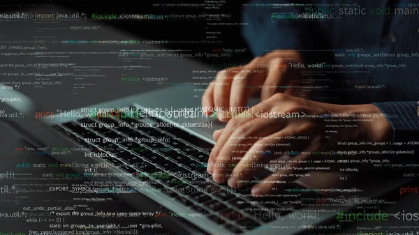 Close-up view of hands typing on a laptop, surrounded by colorful programming code. This image represents software development in a modern workplace, ideal for tech-themed projects. Xenic