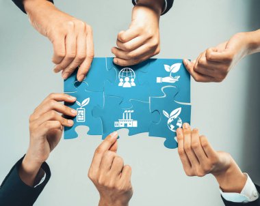 Diverse hands unite to assemble a puzzle piece, representing collaboration for sustainable development, highlighting the importance of teamwork in fostering global partnerships. Amity