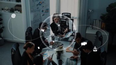 A dynamic business meeting showcasing professionals collaborating around a table, with digital icons symbolizing global connectivity and modern communication tools in a creative workspace. Raster