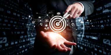A business professional points at a target symbolizing online marketing goals. The image illustrates the fusion of technology and strategy in achieving business success. XDMCP