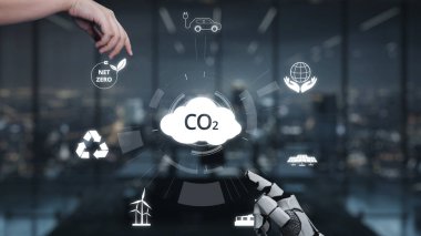 A hand reaches toward a digital cloud symbolizing carbon dioxide, surrounded by eco-friendly icons in a contemporary office, emphasizing sustainability and innovation. Auvana