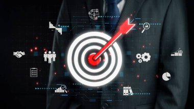 A businessman in formal attire stands next to a target graphic with an arrow indicating success. Digital symbols represent analysis, strategy, and teamwork in the business world. Qubit