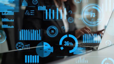 A professional working on a laptop surrounded by dynamic charts and metrics, illustrating the importance of data visualization in driving strategic business decisions. Xenic