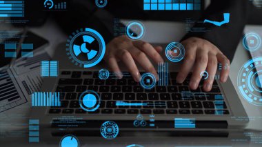 A close-up view of hands typing on a laptop surrounded by vibrant digital data visualizations. This image symbolizes technology, analytics, and innovation in the modern workspace. Xenic