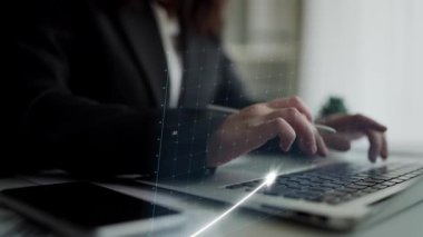 A business professional engages with financial data on a laptop, highlighting the importance of data analysis and technology in enhancing productivity and strategic growth. Copula