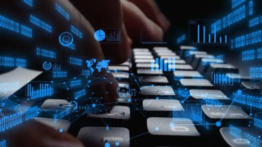 A close-up shot of hands typing on a keyboard amid dynamic digital data visualizations, showcasing the intersection of technology and analysis in a modern workspace. Xenic