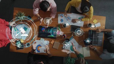 A modern business meeting showcasing teamwork and collaboration while analyzing charts and graphs, with digital tools enhancing decision-making and productivity. Raster