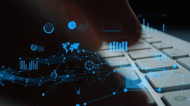 A detailed close-up image showcasing a human finger typing on a keyboard, complemented by vibrant digital data graphics and charts that represent modern data analysis and insights. Xenic