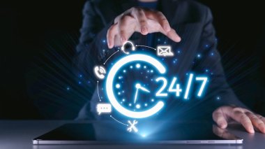 A businessman showcases modern technology with hands poised above a laptop, symbolizing 24 hour customer service in a dark and vibrant atmosphere. Qubit