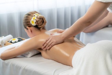 Kafkas çift müşterisi stres önleyici spa masajının keyfini çıkarıyor ve lüks otel veya oteldeki gündüz açık hava ortamında güzellik teniyle eğleniyor. Sessiz.