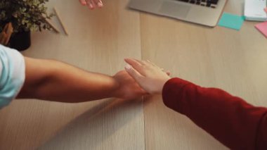 A cozy evening scene featuring friends engaged in a shared moment over a laptop, with feet and hands in focus, surrounded by warm lighting and greenery, highlighting connection. SACTR