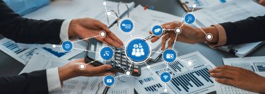 A visual representation of business collaboration using touchscreen devices, surrounded by financial reports, highlighting effective communication and teamwork in a modern office setting. Amity