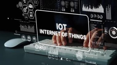 Hands Typing on Keyboard with Digital Display of Internet of Things Concepts and Data Visualization Graphics. Asymptotic smart data analytic.