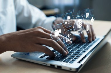 A user interacts with cloud computing technology on a laptop, showcasing online data storage management through a digital interface, emphasizing efficiency and innovation. XDMCP