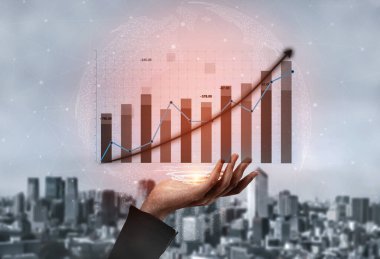 A professional hand presenting a growth chart against a city background symbolizes economic progress and financial success, illustrating business dynamics. Impute