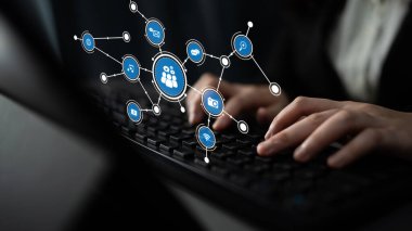 A close-up view of hands typing on a keyboard with digital connection symbols representing networking and communication, highlighting technology in a modern workspace. Tessel