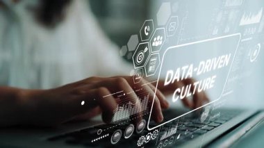 Hands Typing on Laptop with Data-Driven Culture Concept Graphic Overlay for Business and Technology Themes. Asymptotic smart data analytic.