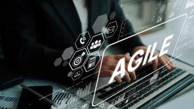 Business Professional Using Laptop with Agile Concept and Digital Interface Overlays in Modern Office Environment. Asymptotic smart data analytic.