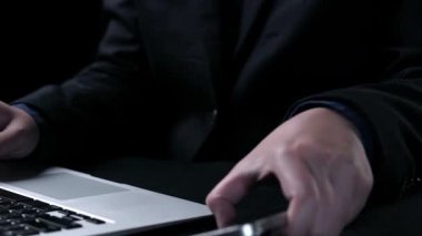 A visual representation of modern cloud computing, showcasing a smartphone and laptop with dynamic data transfer symbols, illustrating digital connectivity and storage solutions. Qubit