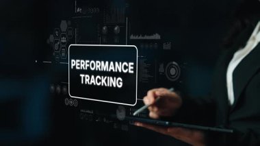 Business professional analyzing performance tracking data on digital interface with graphs and charts in dark environment. Asymptotic smart data analytic.