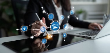 A business professional engages with a digital tablet in a modern office, showcasing a graphic interface that represents technology and connectivity in the workplace. Tessel