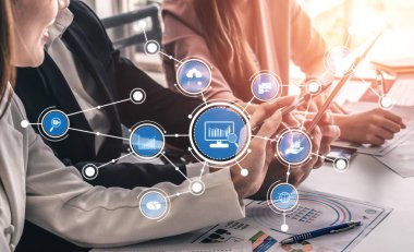 A business team works together using digital technology and data visualization tools to enhance decision-making and collaboration in a modern office environment. Tessel