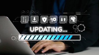 A close-up view of hands on a laptop keyboard during a software update, showcasing a loading progress bar and digital icons in a sleek, modern workspace. Qubit