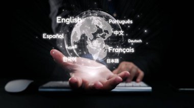 A hand extends toward a glowing globe surrounded by multiple languages, symbolizing global communication and the importance of multilingual connections in today world. Qubit